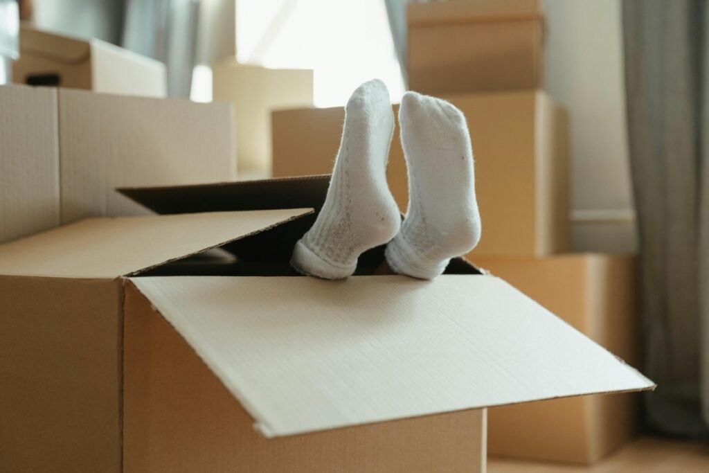Woman fallen into box with only feet showing
